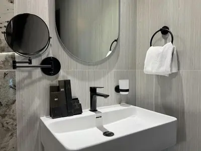 a bathroom with a white sink and a mirror at Studio and One bedroom in Danube Opalz by The S Holiday Homes in Dubai