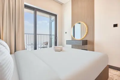 a bedroom with a large white bed and a large window at STAY BY LATINEM Luxury 1BR Holiday Home CB 3813 Near Burj Khalifa in Dubai