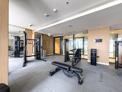 a gym with cardio equipment in a building at Sobha Crest Luxury Apartments in Dubai