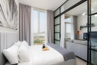 a hotel room with a bed and a living room at Modern Amenities - Great Community in Dubai