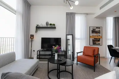 a living room with a couch and a table at Modern Amenities - Great Community in Dubai