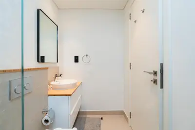 a bathroom with a sink and a mirror at Modern Amenities - Great Community in Dubai
