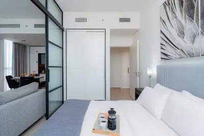 a bedroom with a white bed and a couch at Modern Amenities - Great Community in Dubai