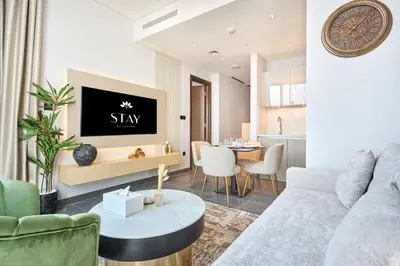 a living room with a couch and a table at STAY BY LATINEM Luxury 1BR Holiday Home CB 3602 Near Burj Khalifa in Dubai