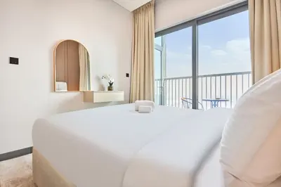 a white bedroom with a large bed and a large window at STAY BY LATINEM Luxury 1BR Holiday Home CB 3602 Near Burj Khalifa in Dubai