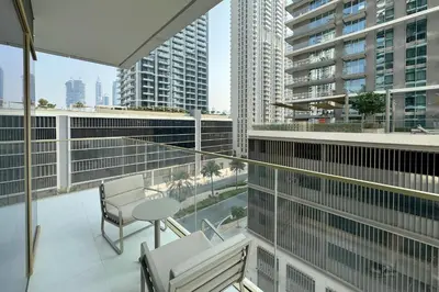 a balcony with a view of a city with tall buildings at 1BR Sea View at Grand Bleu - Emaar Beachfront in Dubai