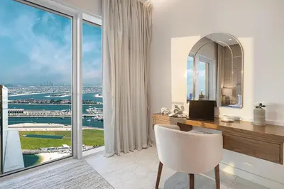 a room with a desk and a large window at La Brisa Exclusive 3BHK at 1JBR Sea Palm Royal Atlantis Burj AlArab View with Private Beach and Pool By La Brisa Dubai in Dubai