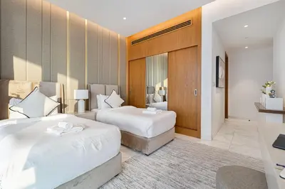 a hotel room with two beds and a desk at La Brisa Exclusive 3BHK at 1JBR Sea Palm Royal Atlantis Burj AlArab View with Private Beach and Pool By La Brisa Dubai in Dubai