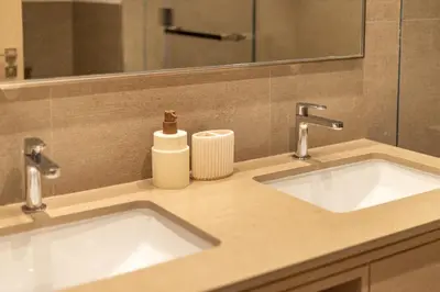 a bathroom counter with two sinks and a mirror at Stunning Burj View High Floor EB in Dubai