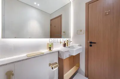 a bathroom with a sink and a mirror at Modern Studio on High Floor with Stunning City Views near Circle Mall and Community Parks - Binghatti Tulip, JVC - by Deluxe Holiday Homes in Dubai