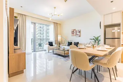 a dining room and living room with a table and chairs at Partial Creek Harbour Views, Close to the Creek Harbour Marine Station and Harbour Promenade, Just Minutes from a Park, Harbour Views Tower 2, Dubai Creek Harbour by Deluxe Holiday Homes in Dubai