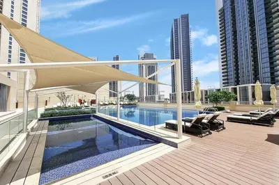 a swimming pool on a building with chairs and a umbrella at Partial Creek Harbour Views, Close to the Creek Harbour Marine Station and Harbour Promenade, Just Minutes from a Park, Harbour Views Tower 2, Dubai Creek Harbour by Deluxe Holiday Homes in Dubai