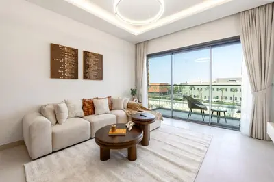 a living room with a couch and a large window at Elegant 1 Bedroom with Balcony in City Walk in Dubai