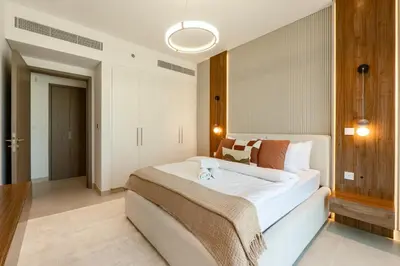 a bedroom with a large white bed in a room at Elegant 1 Bedroom with Balcony in City Walk in Dubai
