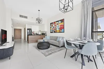 a living room with a couch and a table at VayK - Great 1BR Apartment in Damac Hills in Dubai