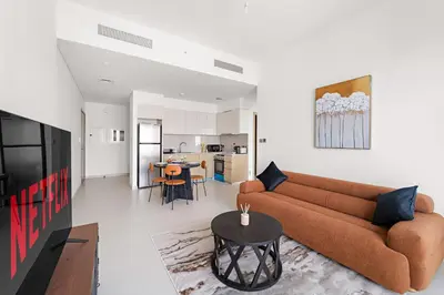 a living room with a couch and a table at VayK - Stylish 1BR in Iconic Downtown Location in Dubai