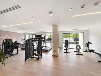 a gym with treadmills and ellipticals in a room at VayK - Stylish 1BR in Iconic Downtown Location in Dubai