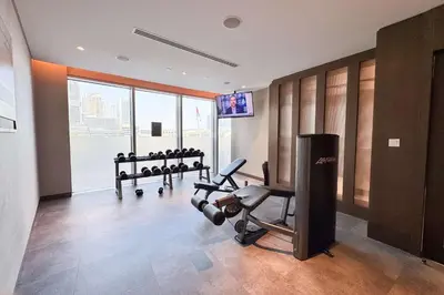 a fitness room with a gym with tread machines at PVH - Elegant 2BR near Dubai Mall - Opera Grand in Dubai