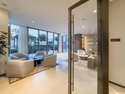 a lobby with white furniture and glass doors at Luxury Grande Signature Apartment in Dubai Downtown Steps to Dubai Mall and Burj Khalifa with Stunning Pool View by La Brisa Dubai in Dubai