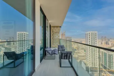 a balcony with chairs and a view of the city at GuestReady - High floor Luxury with a Private Pool in Dubai