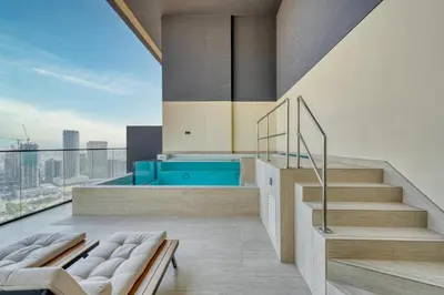 a bathroom with a plunge pool and stairs and a view at GuestReady - High floor Luxury with a Private Pool in Dubai
