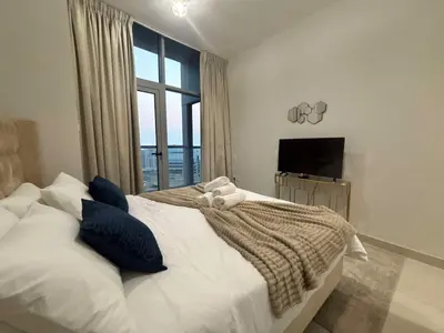 a bedroom with a large bed with a window at Marina Sunset Haven - Breathtaking Views in Dubai