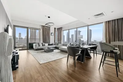 a living room with a table and a couch at Luxury 2BR Walk-In Closet Full Burj Khalifa View in Dubai