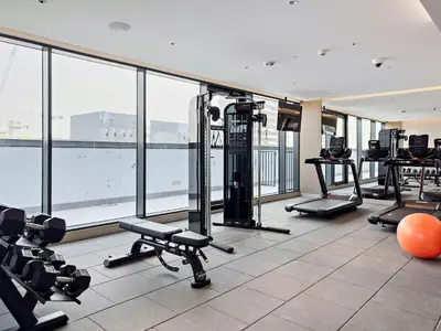 a gym with treadmills and machines in a building at Inspiring 1BR Apartment at Sobha Hartland in Dubai