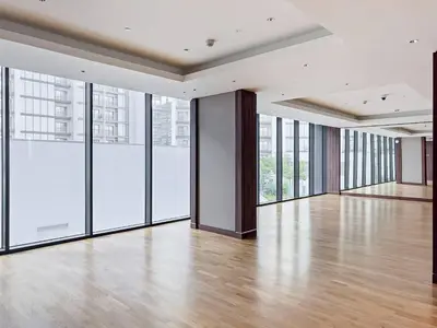 an empty room with large windows and a wooden floor at Inspiring 1BR Apartment at Sobha Hartland in Dubai