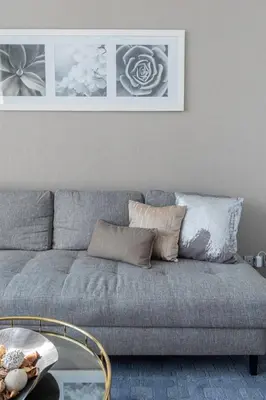 a living room with a gray couch and a table at GuestReady - Damac Prive | 1BR Canal View in Dubai