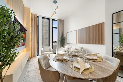 a dining room with a table and chairs at Cozy 1 Bedroom in JVC with Stunning City Views in Dubai