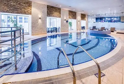 a large swimming pool in a hotel lobby at Full Luxury 2 Bedrooms Apartment, Princess Tower in Dubai
