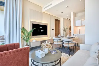 a living room with a couch and a table at STAY BY LATINEM Luxury 1BR Holiday Home CB 0810 Near Burj Khalifa in Dubai