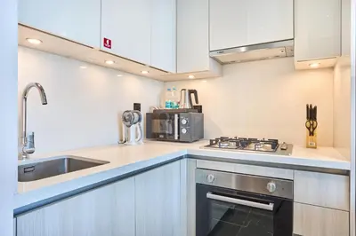 a kitchen with a sink and a stove at STAY BY LATINEM Luxury 1BR Holiday Home CB 0810 Near Burj Khalifa in Dubai