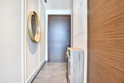 a hallway with a wooden door and a mirror at STAY BY LATINEM Luxury 1BR Holiday Home CB 0810 Near Burj Khalifa in Dubai