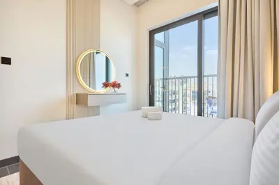 a bedroom with a large white bed and a large window at STAY BY LATINEM Luxury 1BR Holiday Home CB 0810 Near Burj Khalifa in Dubai