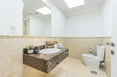 a bathroom with a sink and a toilet at Central JBR Home Steps away from the Beach in Dubai