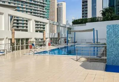 a swimming pool in the middle of a building at Park Central, Business Bay - Studio Apartment - Allsopp & Allsopp in Dubai