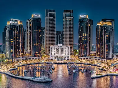 a view of a city at night with tall buildings at Huge Modern 1BR in Creek Harbour steps to Central Park with a creek view and infinity pool by La Brisa Dubai in Dubai