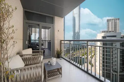a balcony with a couch and a table on a building at Huge Modern 1BR in Creek Harbour steps to Central Park with a creek view and infinity pool by La Brisa Dubai in Dubai