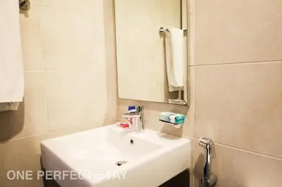a bathroom with a white sink and a mirror at Elegant 3BR Villa - Peaceful - Family Friendly in Dubai