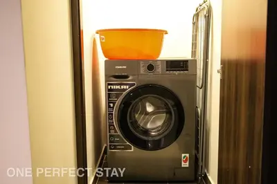 a washing machine with a basket on top of it at Elegant 3BR Villa - Peaceful - Family Friendly in Dubai