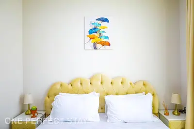 a bed with a yellow headboard in a bedroom at Elegant 3BR Villa - Peaceful - Family Friendly in Dubai