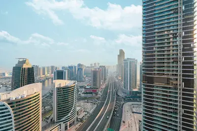 a view of a city with many tall buildings at Elegant 1-Bedroom Apartment at Downtown Dubai with Stunning Canal & Skyline Views in Dubai