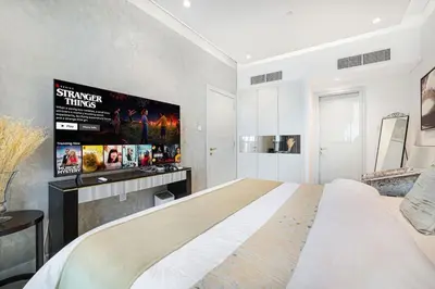 a bedroom with a large bed in a room at Elegant 1-Bedroom Apartment at Downtown Dubai with Stunning Canal & Skyline Views in Dubai