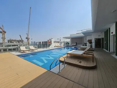 a swimming pool on the deck of a cruise ship at Elegant Studio Escape in JVC - by Czechin in Dubai