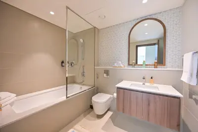a bathroom with a sink and a toilet and a bath tub at Vida Residences - Luxury & Serenity - Creek Beach in Dubai