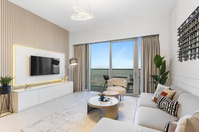 a living room with a couch and a tv at Skyline Splendor 2bedroom with Burj Khalifa View in Dubai