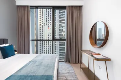 a bedroom with a large bed and a mirror at Downtown views 1 Bedroom 5 PAX direct Dubai mall in Dubai
