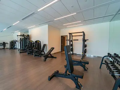 a gym with rows of exercise equipment in a room at Downtown views 1 Bedroom 5 PAX direct Dubai mall in Dubai